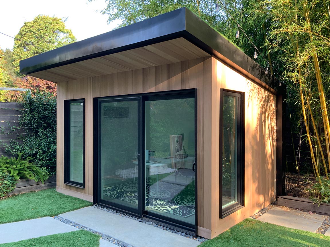 a glass house with a glass door with HP Garage in the background