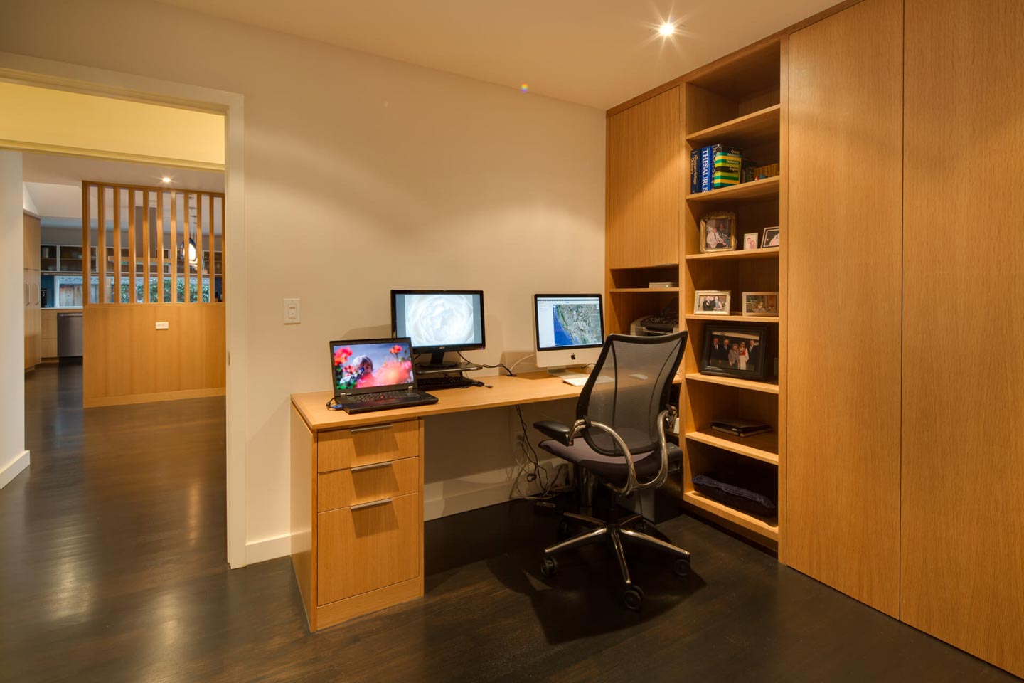 a room with a desk and computers